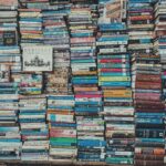 A vibrant collection of stacked books creating a visually arresting pattern in a Dhaka bookstore.